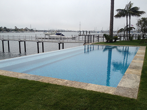 Antique Stone Pool Coping Slabs Milled at 2.5" in Thickness Installed in a pool in a Custom Home in Newport Beach